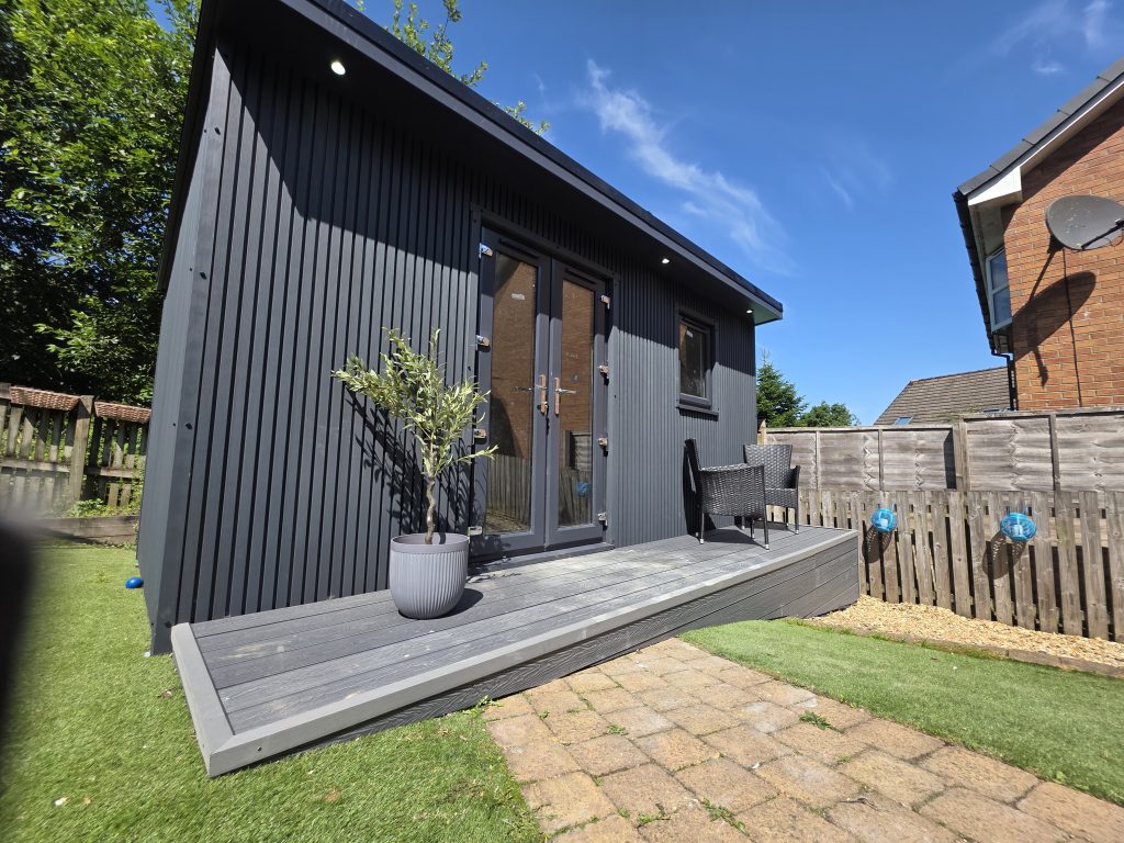 Modern black garden room with deck